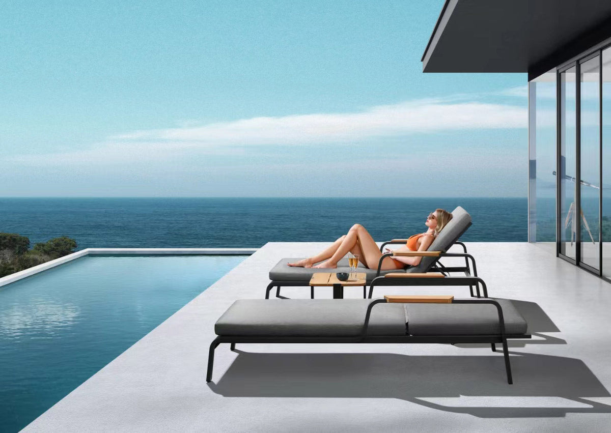 Viscounti black aluminum and teak chaise lounge with side table – shown outdoors (5)