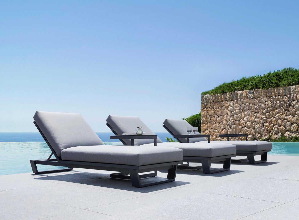 Pagino black aluminum chaise lounge with cushion – shown outdoors (4)