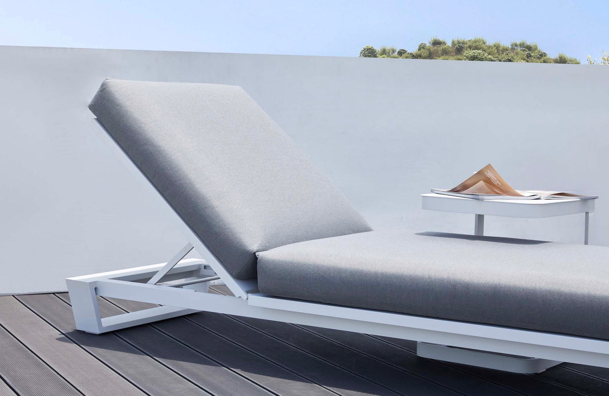 Pagino white aluminum chaise lounge with gray cushion – shown outdoors (4)