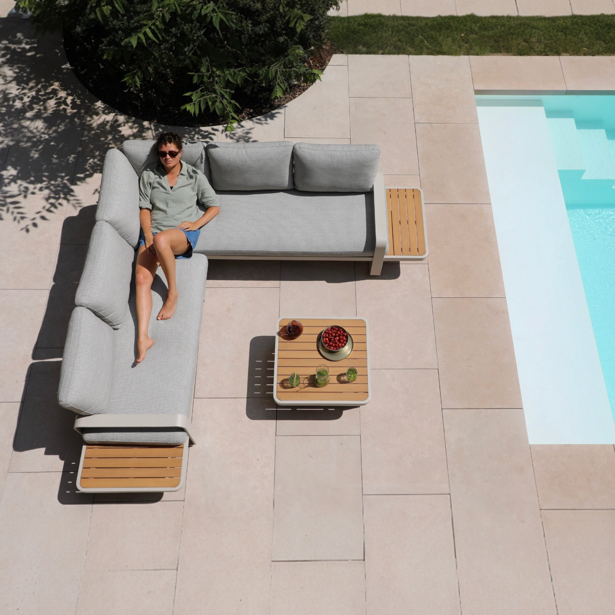 Emilia beige aluminum and teak modular outdoor sectional – shown outdoors