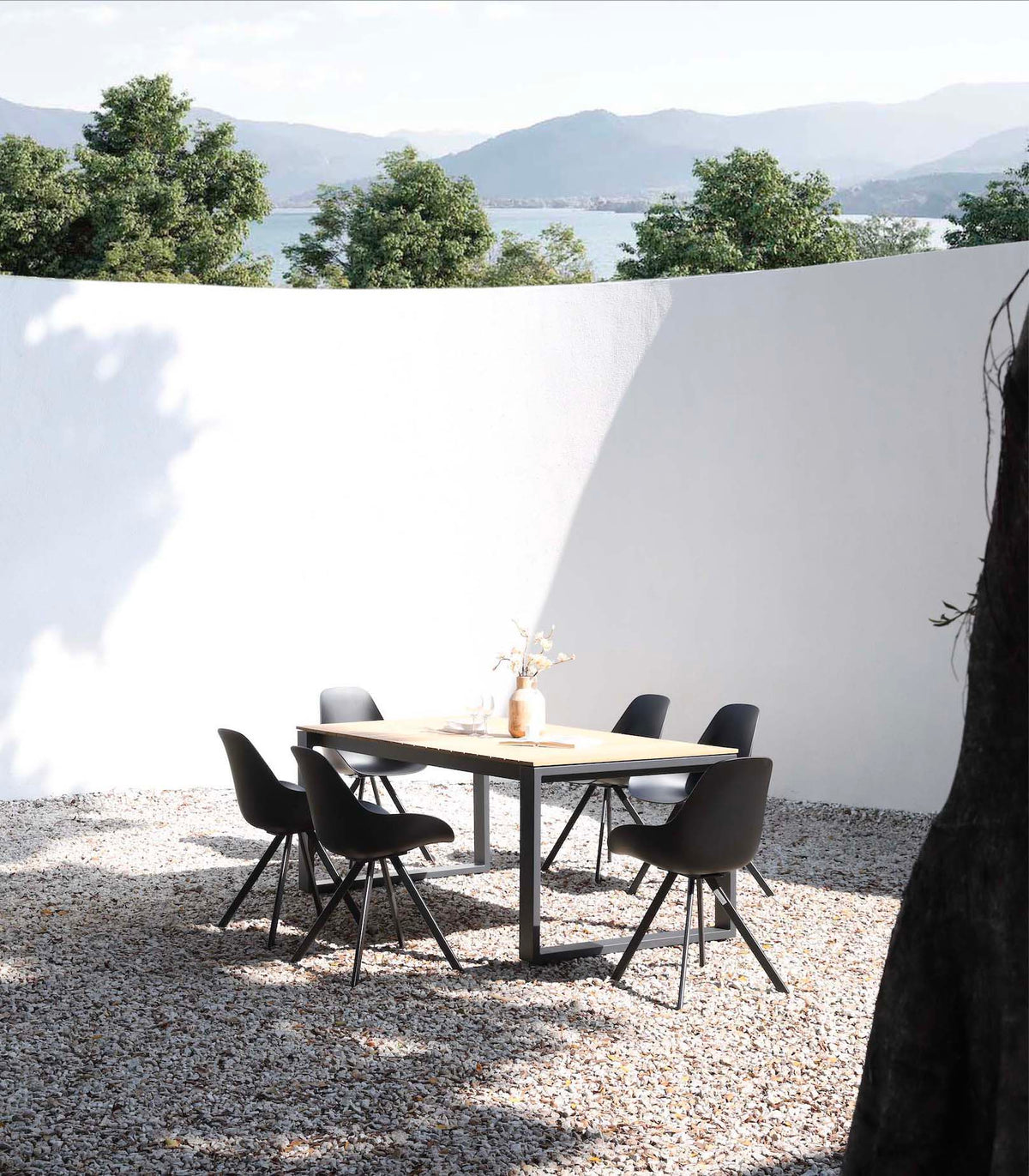 Como black aluminum and teak outdoor dining table, 200 cm – shown outdoors (3)