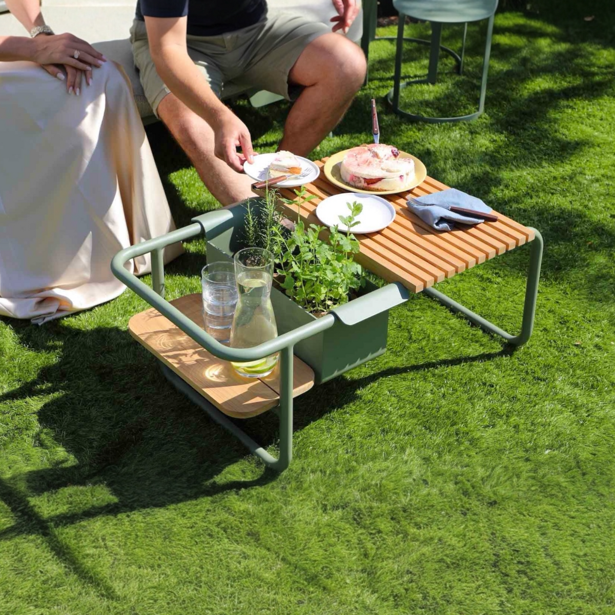 Sunny aluminum coffee table with teak center and drink cooler – shown outdoors