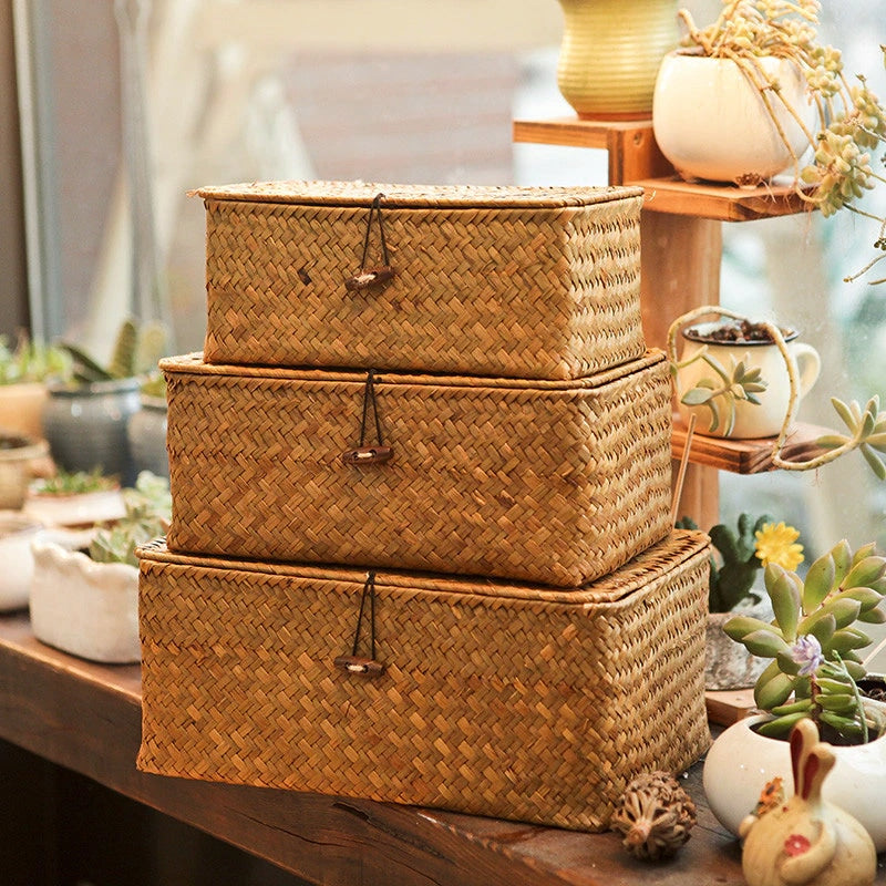 Hand-braided rattan storage basket with a lid, hook and side handles – shown in a room setting