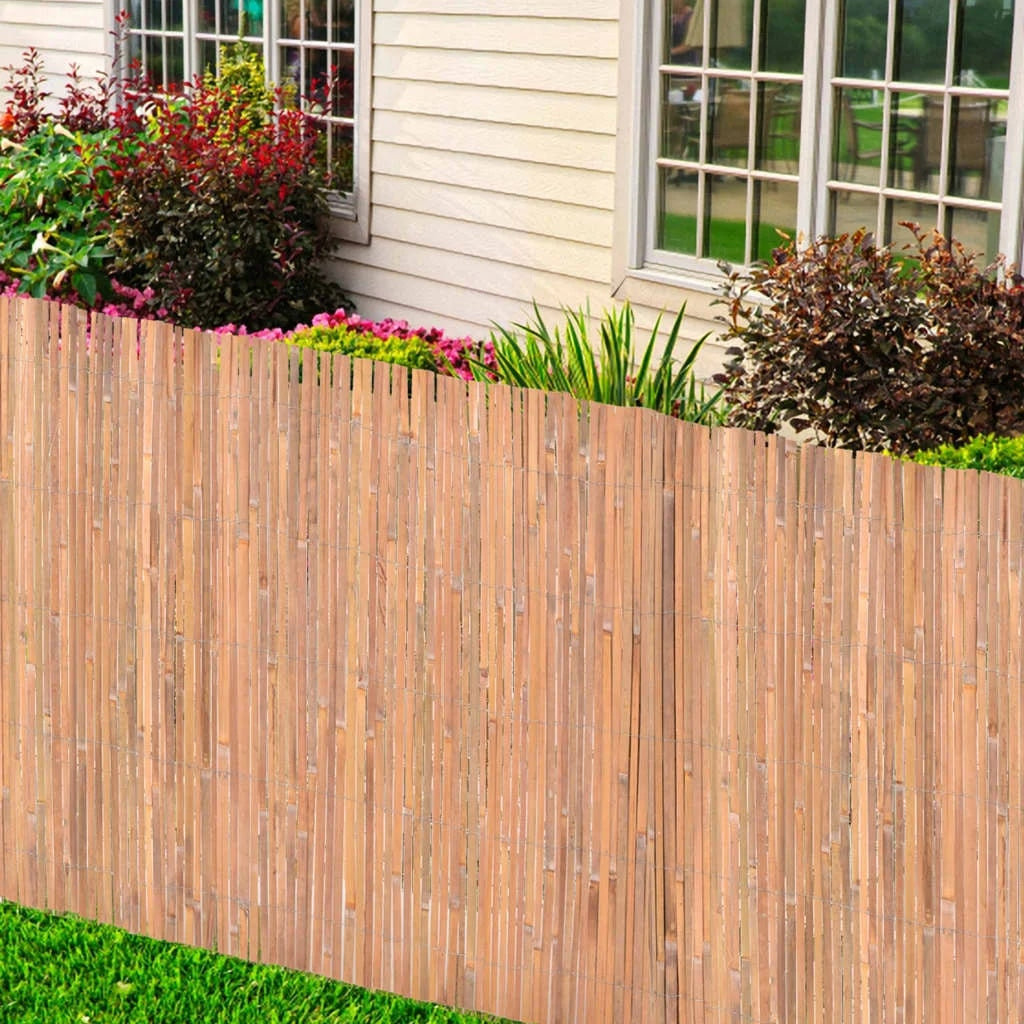 Natural bamboo fence screen with golden-beige stems – shown outdoors