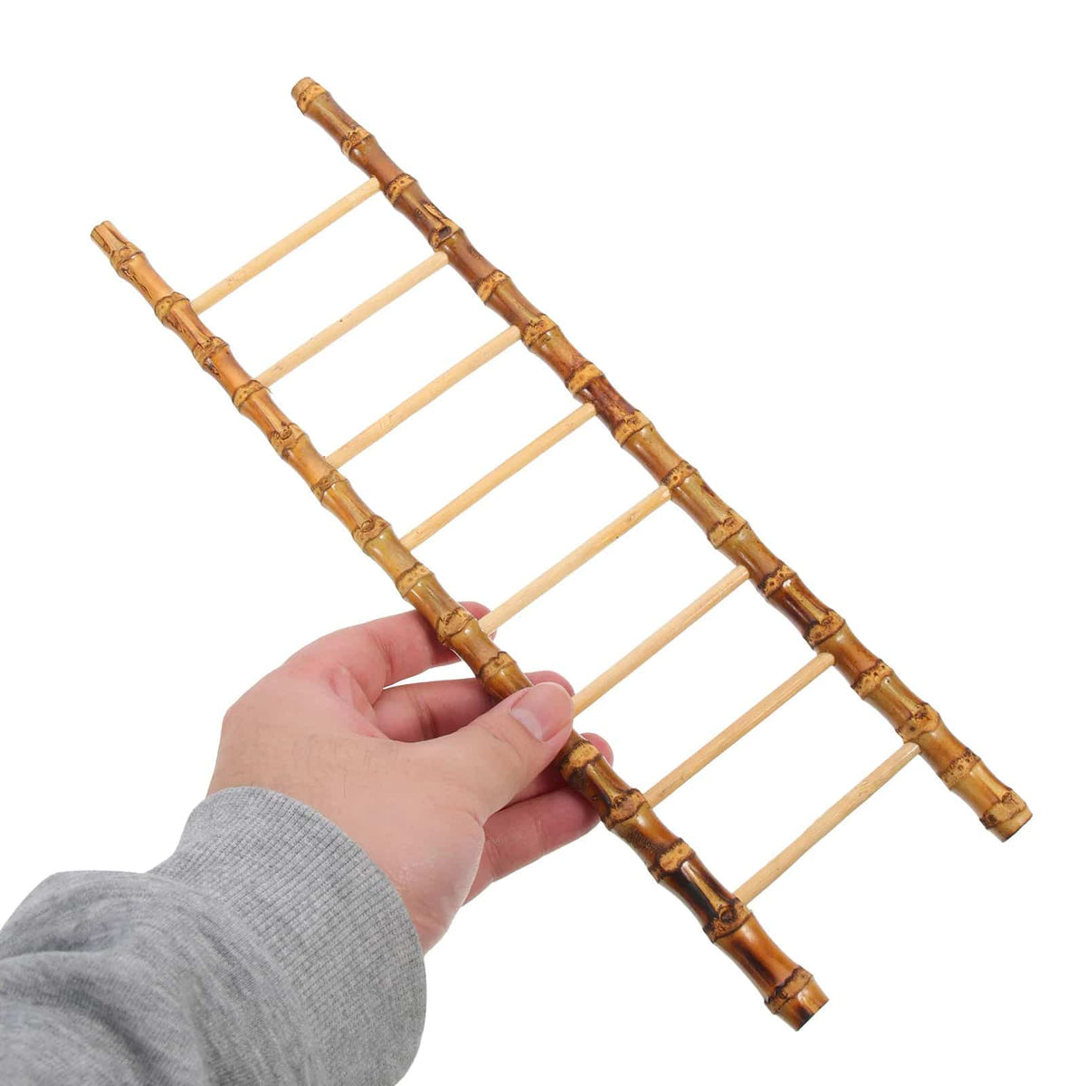 Slim decorative bamboo ladder leaning against a wall – shown in use