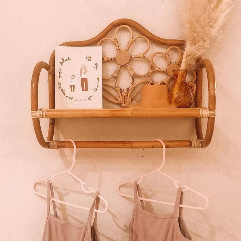 Bench-shaped rattan wall shelf with hand-braided legs – shown in a room setting