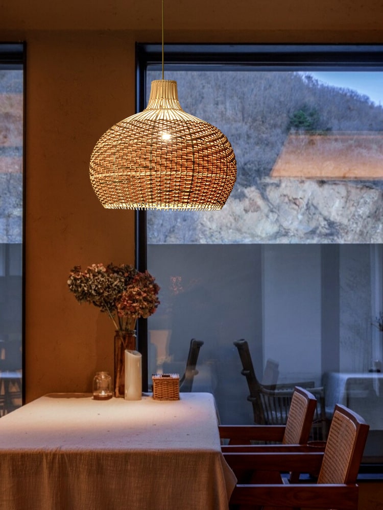 Vintage round rattan pendant light with wood accents – shown in a room setting (3)