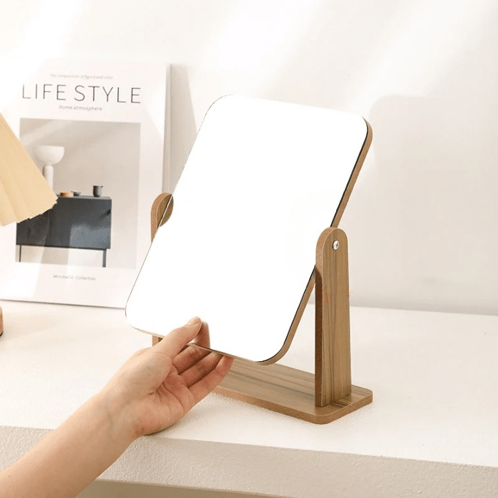 Rectangular swivel bamboo vanity mirror on a stand – shown in use
