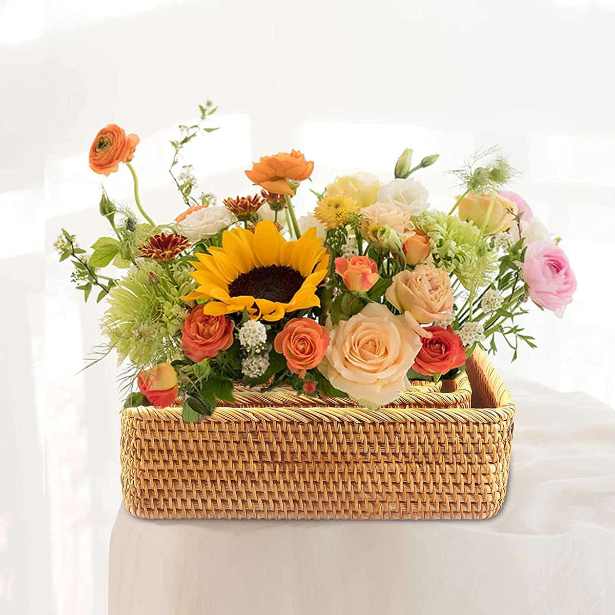 Rectangular handwoven rattan and wicker storage basket – shown in a room setting