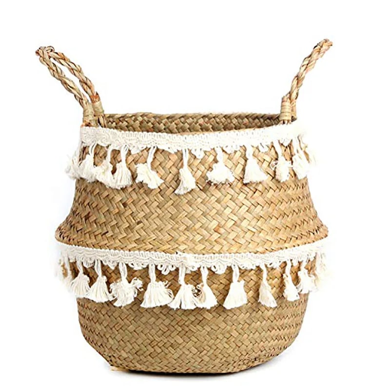 Rounded wicker basket trimmed with cotton tassels