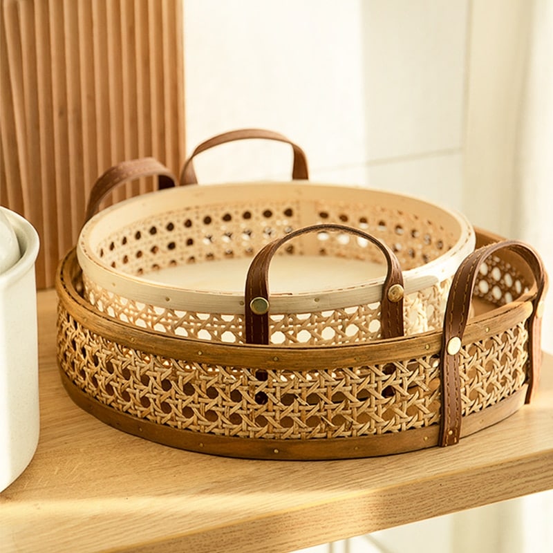 Round white rattan tray with a sewn leather handle – shown in a room setting (3)
