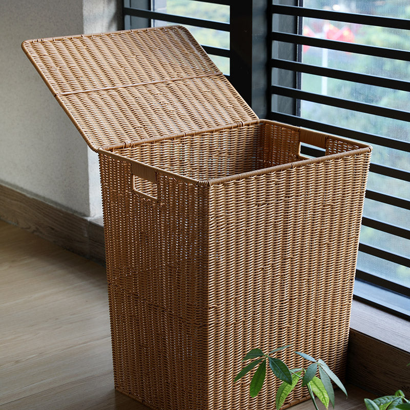 Hand-braided indoor-outdoor rattan trash can with a lid – shown in a room setting