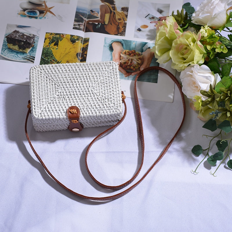 Square boho handwoven rattan handbag – white variant, shown in a room setting