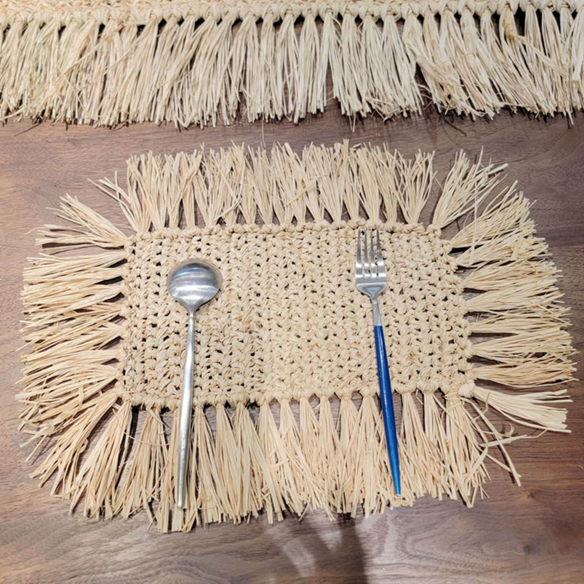 Rectangular hand-braided beige straw placemat – shown in a room setting