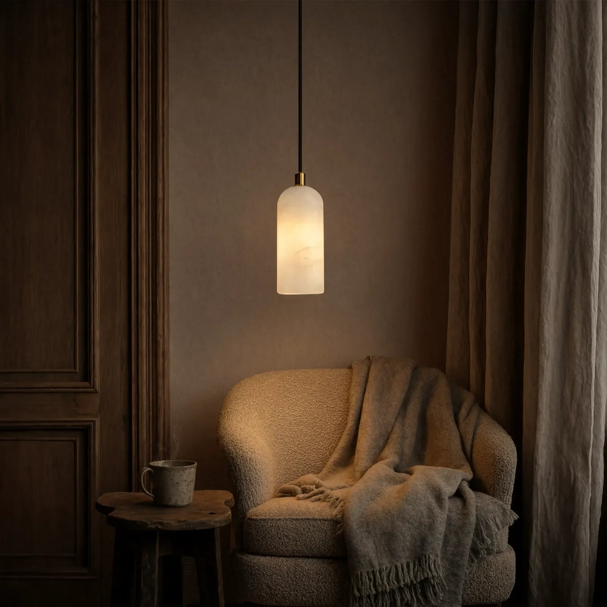 Tarente translucent marble pendant light with brushed brass canopy – shown in a room setting