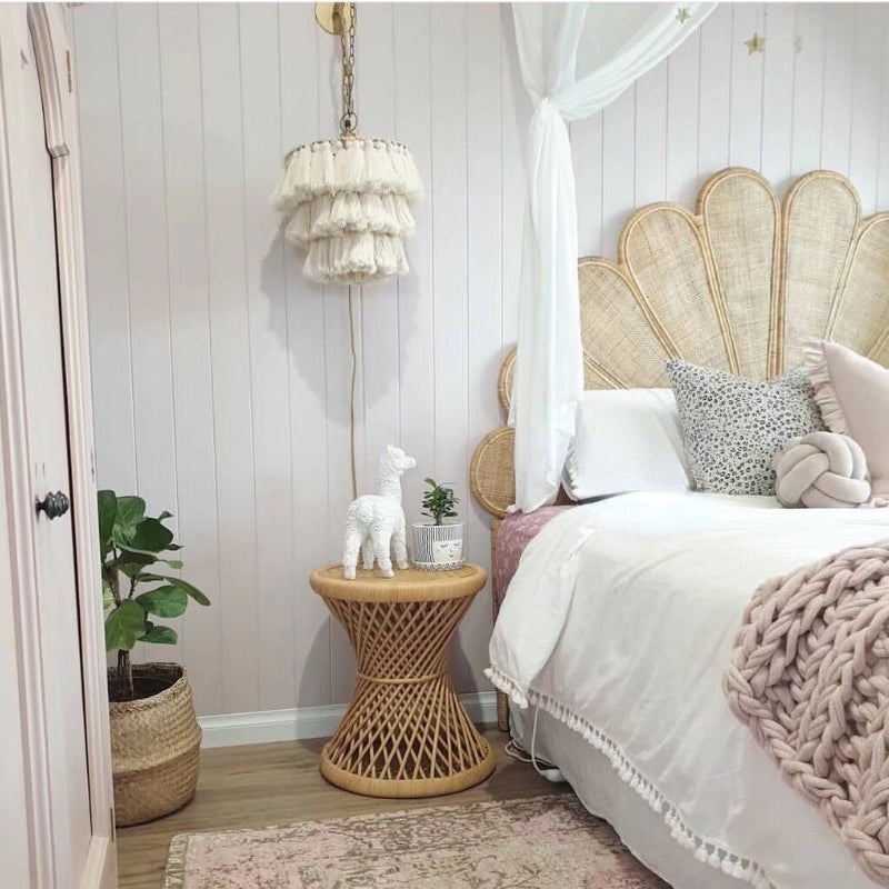 Half-moon light rattan headboard with eight radiating segments – shown in a room setting