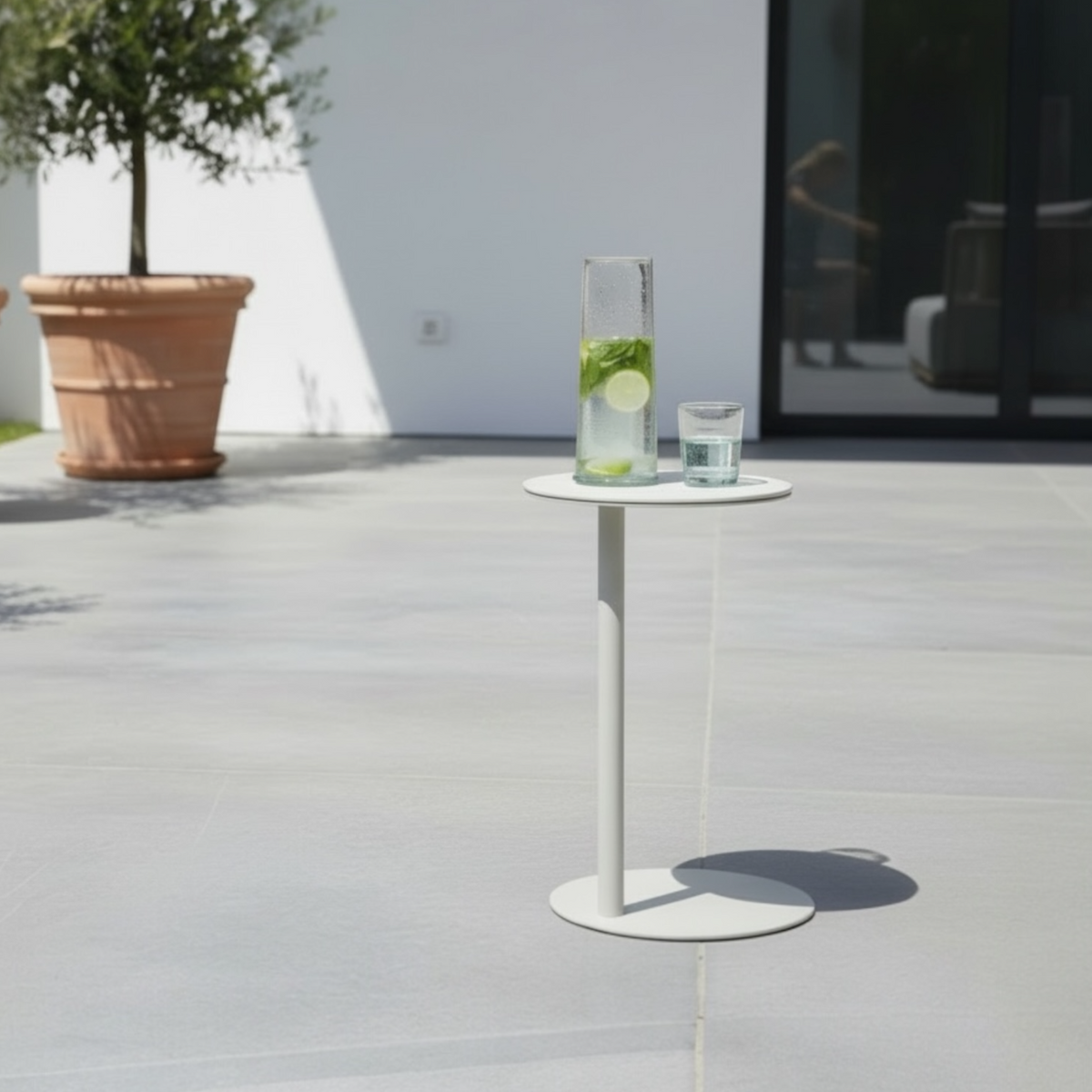 Bulter beige aluminum round ceramic side table – shown outdoors