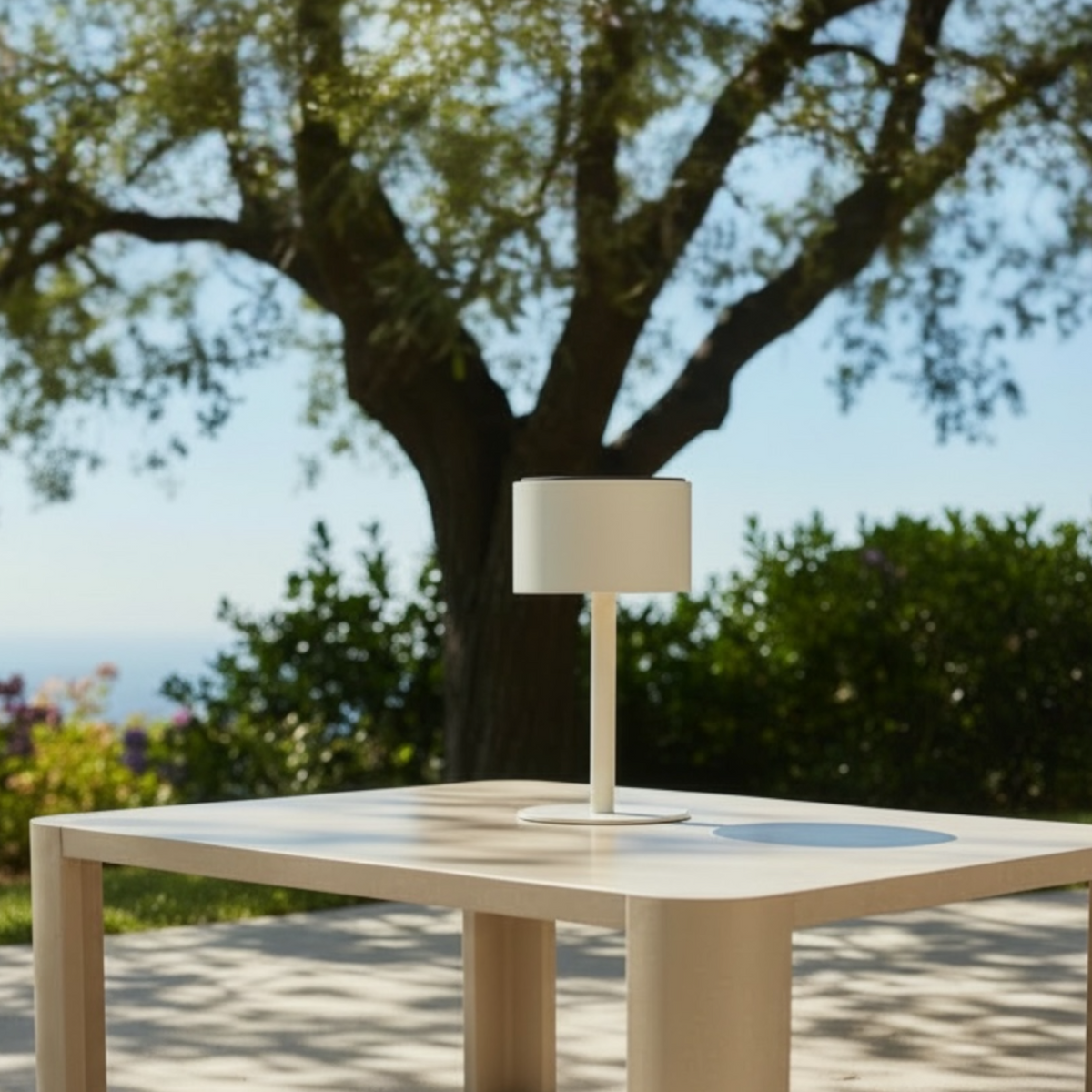 Arlo Round beige aluminum solar lamp – shown outdoors
