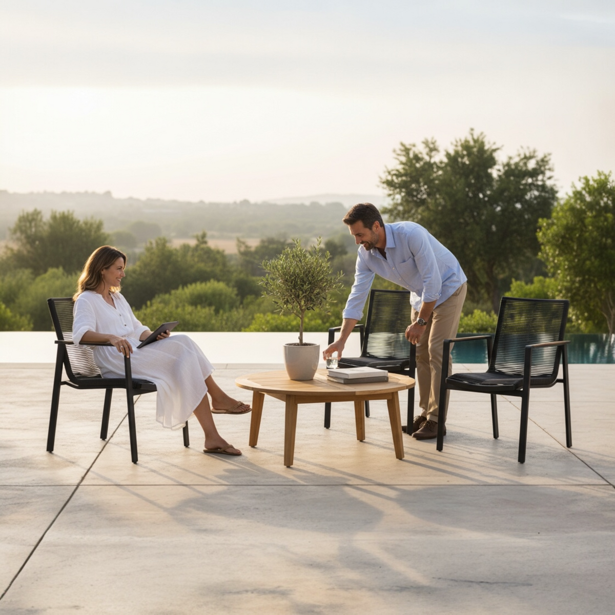 Noffy stackable aluminum restaurant patio chair with teak armrests – shown outdoors (2)