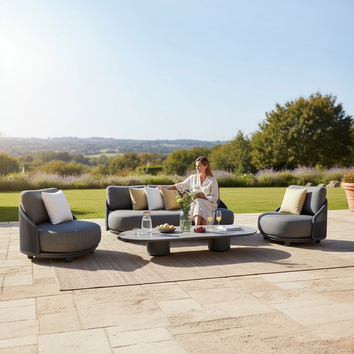 Aura black rope outdoor lounge set with gray-taupe marble-effect coffee table – shown outdoors