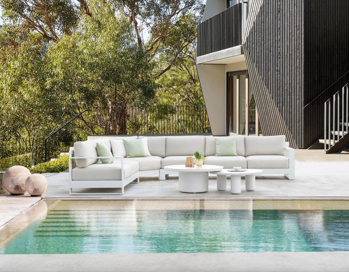 Iris small round aluminum ceramic-top coffee table – shown outdoors