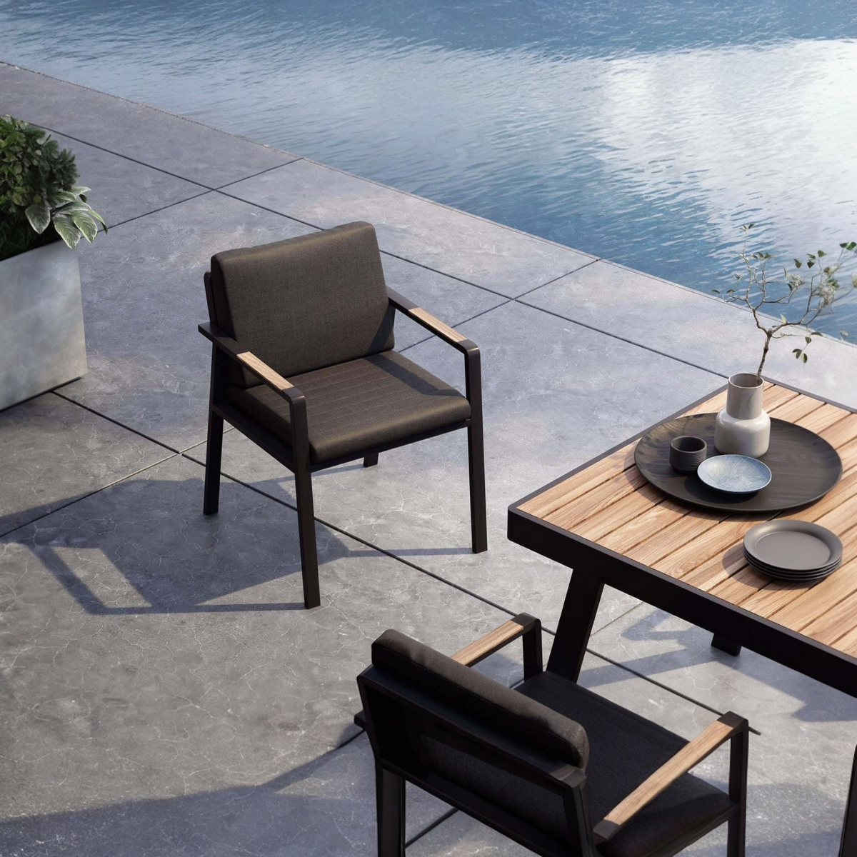 Noffy black aluminum and teak dining armchair – shown outdoors