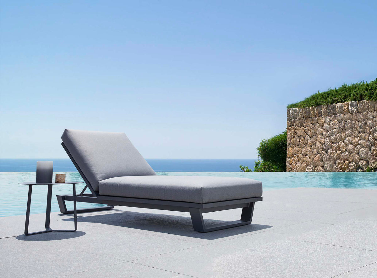 Pagino black aluminum chaise lounge with cushion – shown outdoors (3)