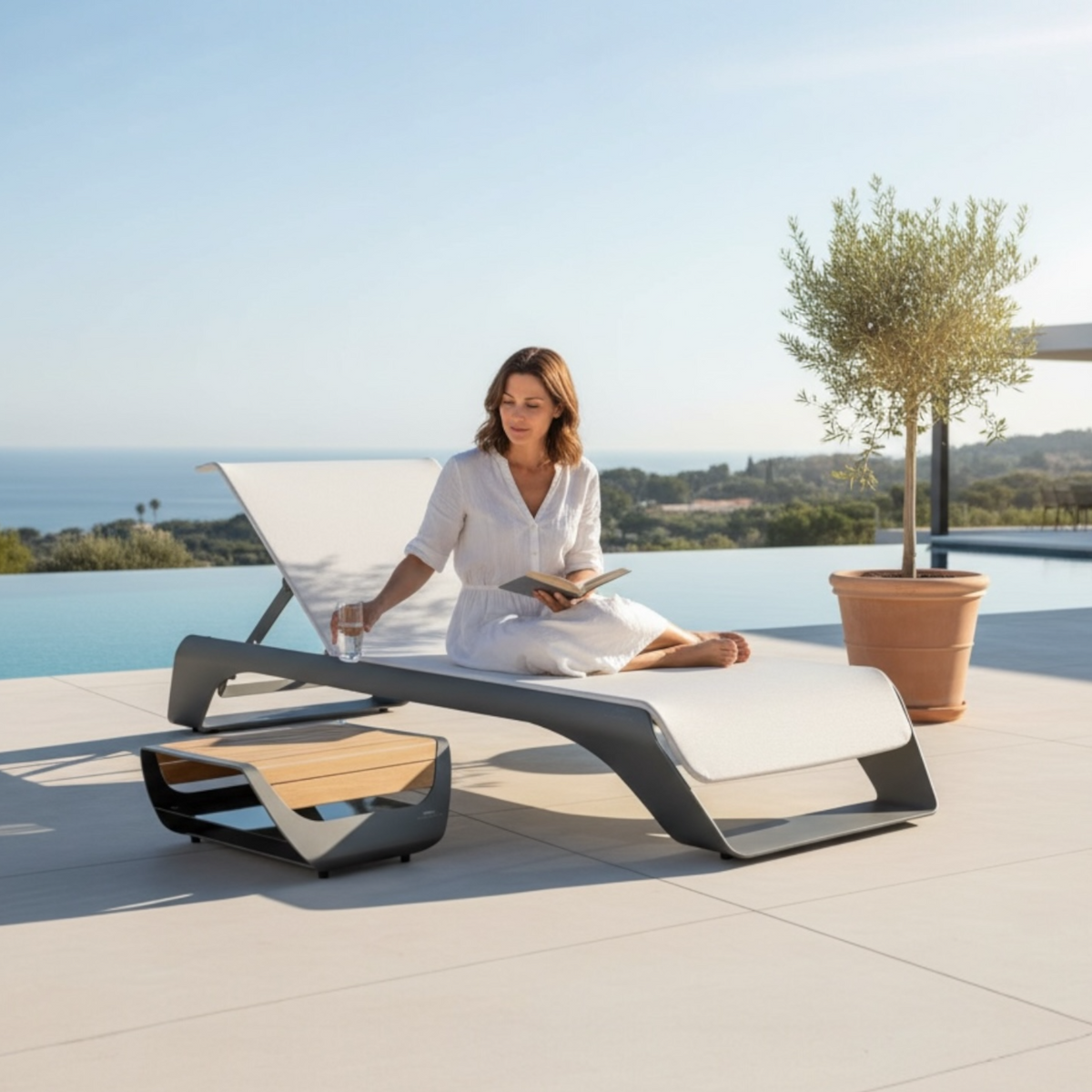 Onda gray aluminum pool lounger with side table – shown outdoors