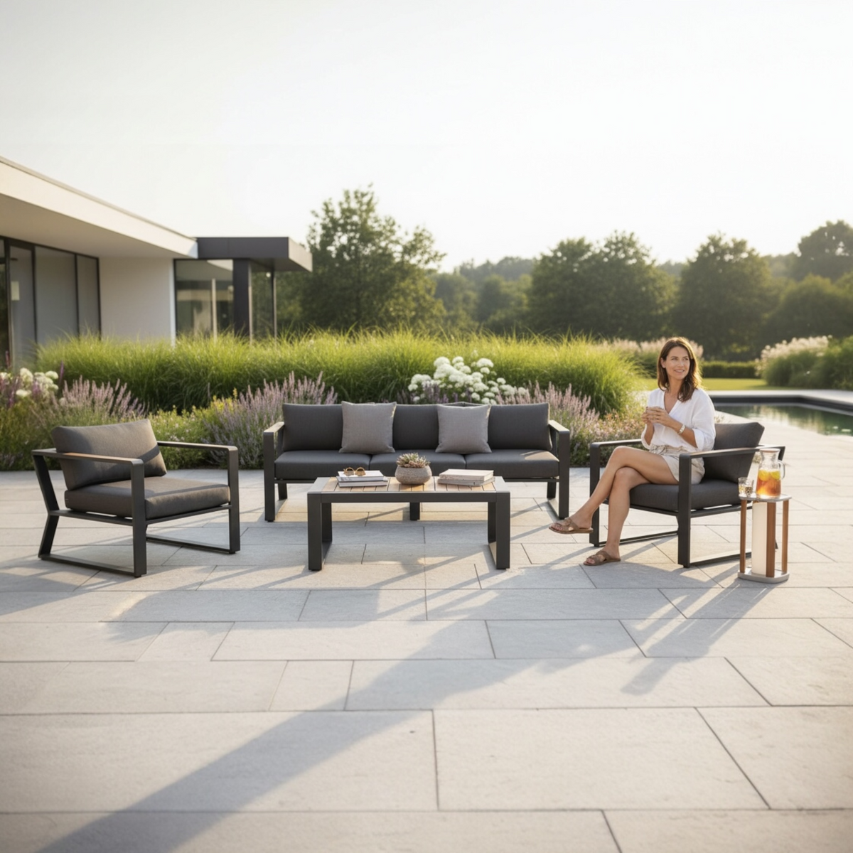 Exy anthracite aluminum and teak 5-seat patio set with teak coffee table – shown outdoors (2)