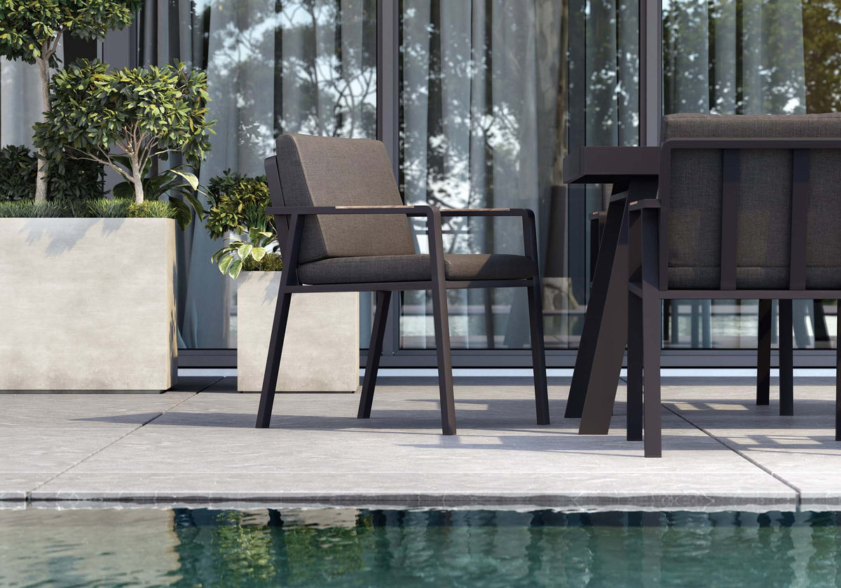 Noffy black aluminum and teak dining armchair – shown outdoors (2)