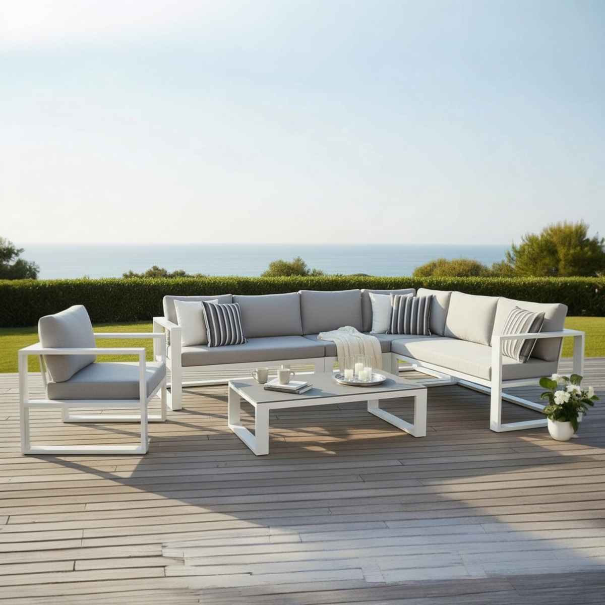 Belly white aluminum outdoor sectional with armchair and tinted glass table – shown outdoors