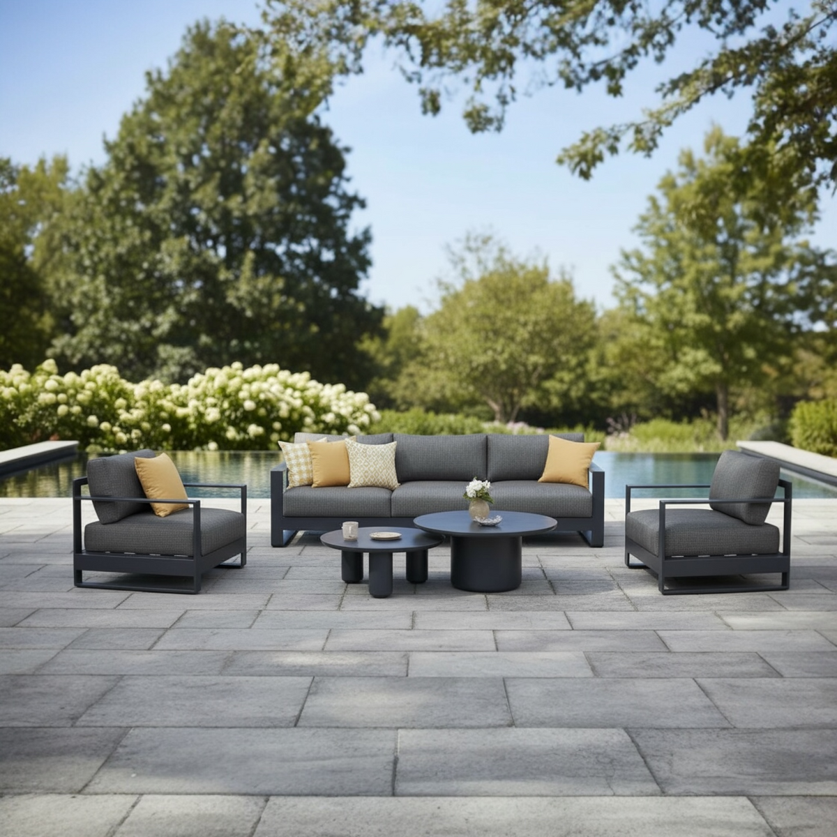 Iris Bis black modular aluminum patio set with gray cushions and ceramic tables – shown outdoors