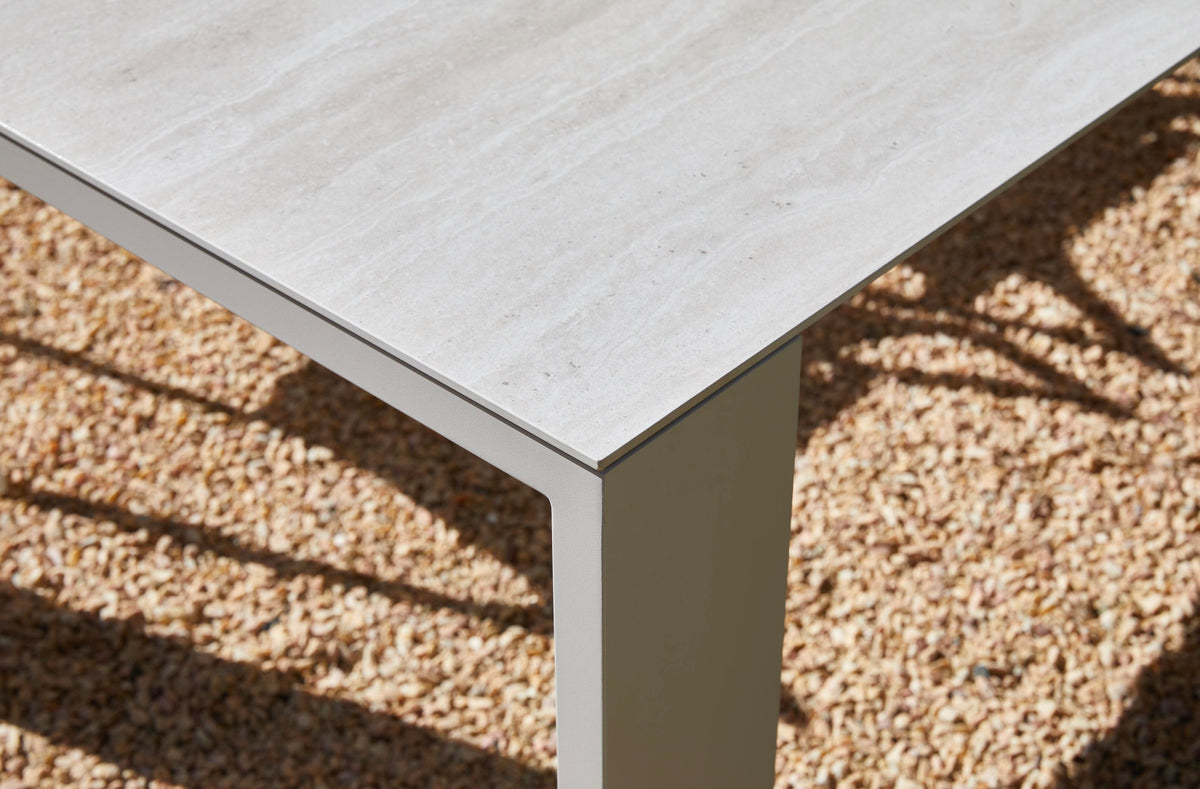 Jules pearl gray ceramic and beige aluminum outdoor dining table – close-up detail