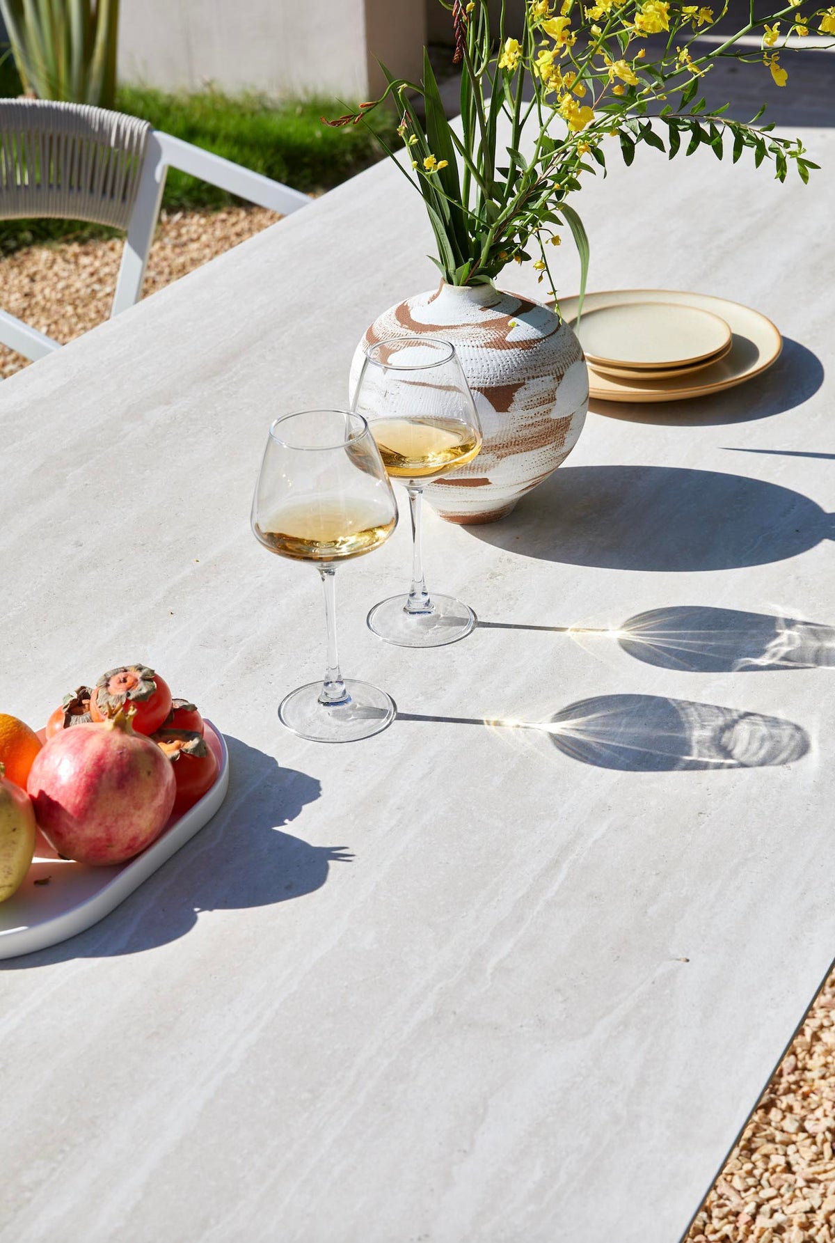Jules pearl gray ceramic and beige aluminum outdoor dining table – shown outdoors (5)