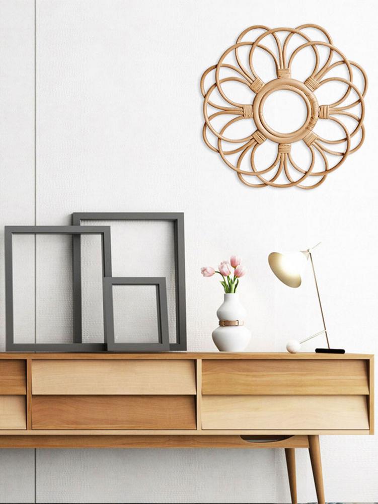 Round floral rattan wall frame with hand-braided petals – shown in a room setting (2)