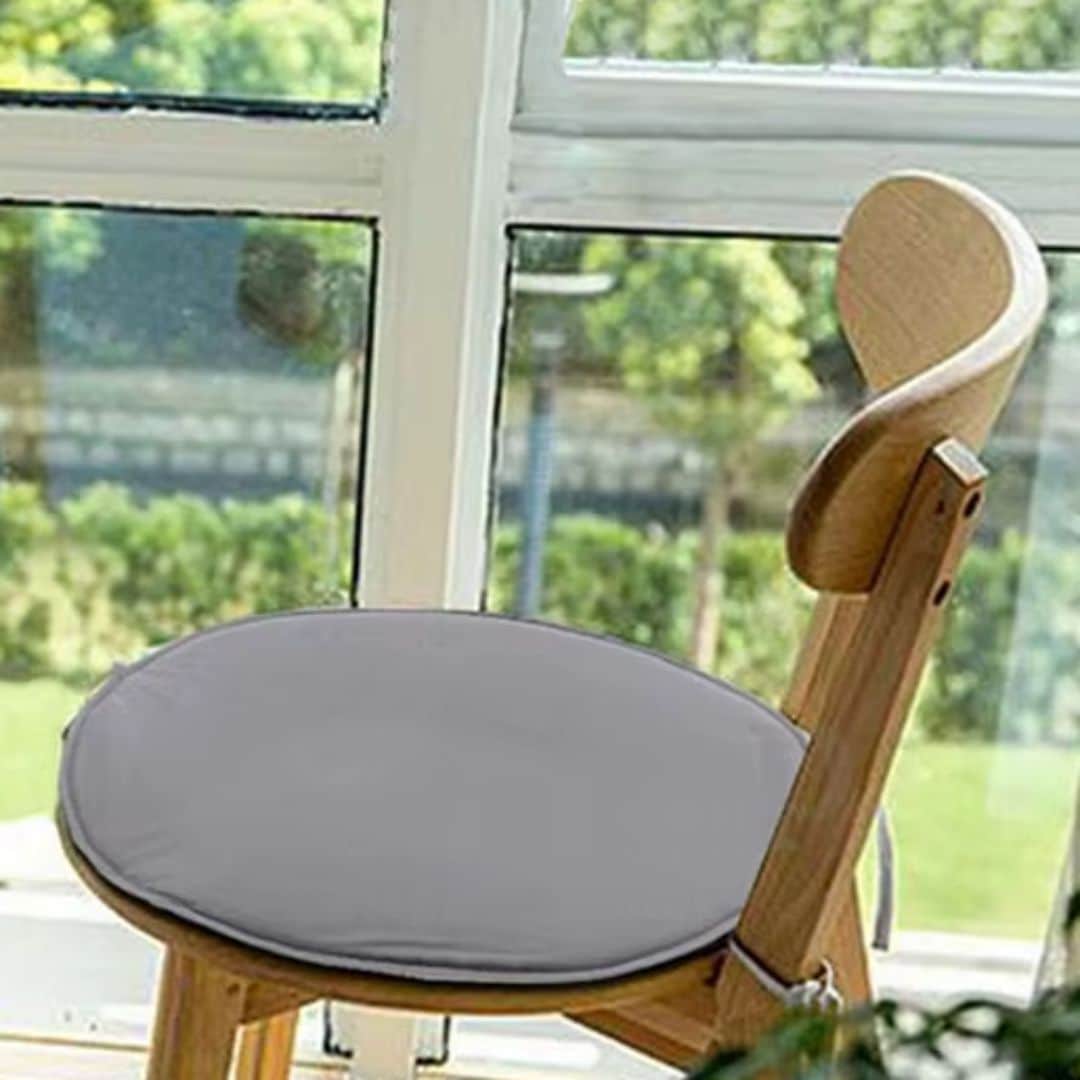Round tie-on chair cushion – gray version, shown in a room setting