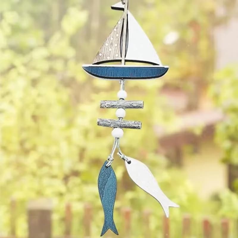 Blue and white wooden wall decor with a sailboat and fish – shown outdoors