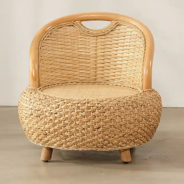 Low beige rattan armchair with rounded arms