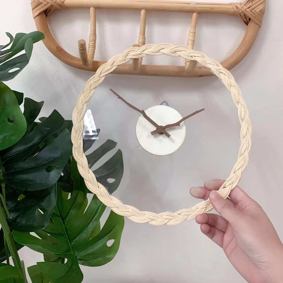 Minimal rattan wall clock with branch-like rattan hands – shown in use