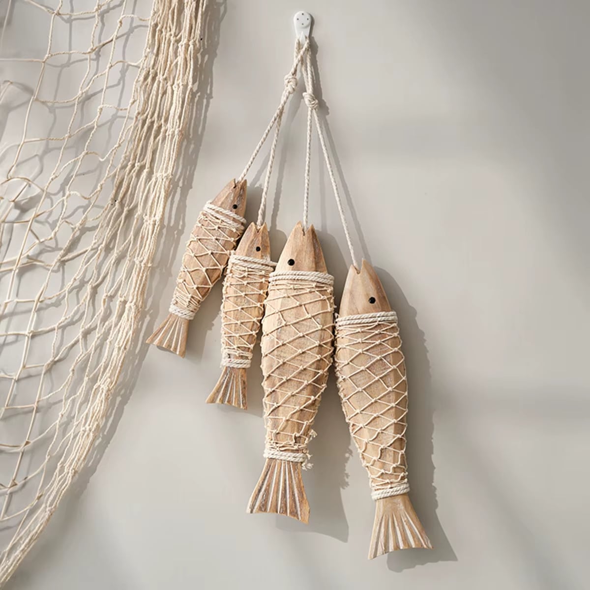 Set of two carved wooden fish wall decorations – shown in a room setting (2)