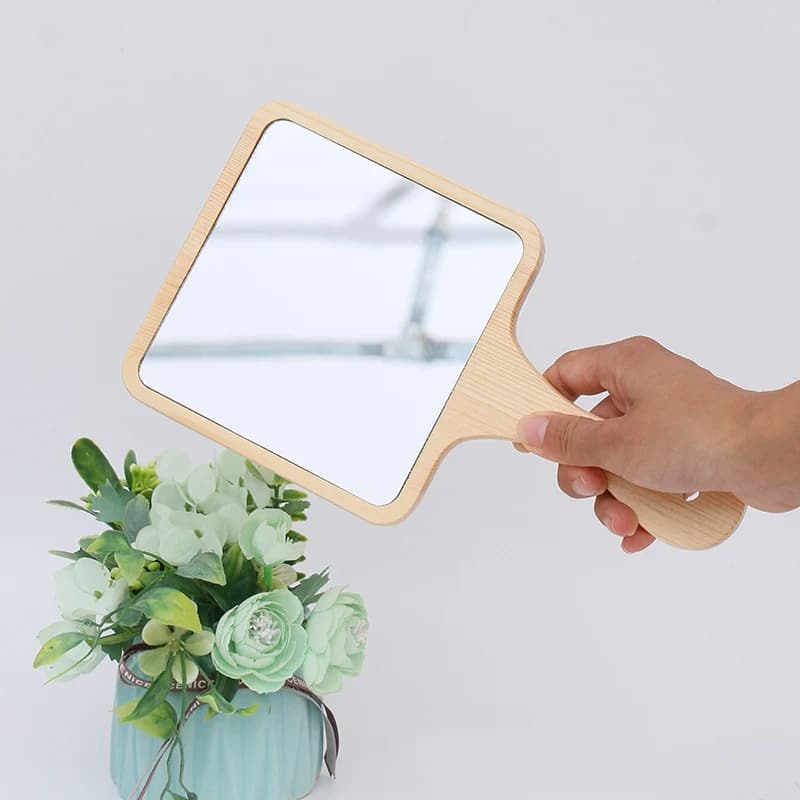 Square wooden hand mirror – shown in use