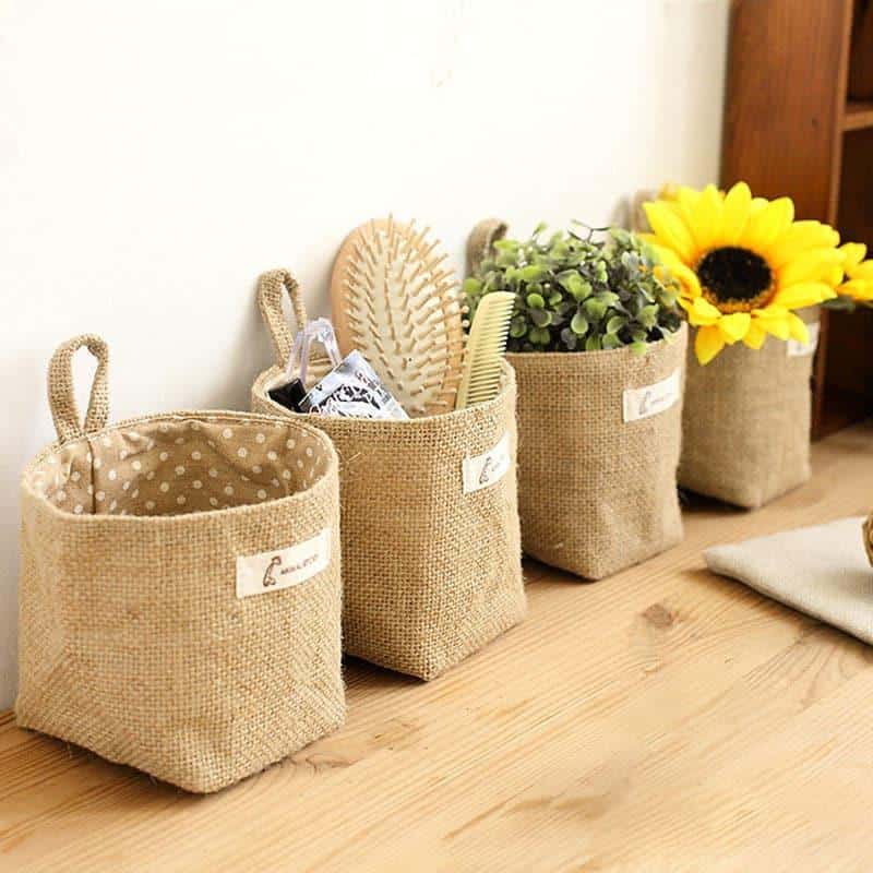 Hanging cotton and linen storage pocket with a reinforced handle – shown in a room setting (2)