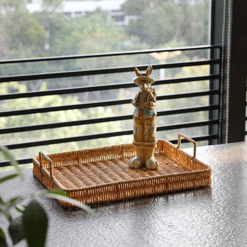 Brown plastic rattan-look tray with side handles – shown in a room setting