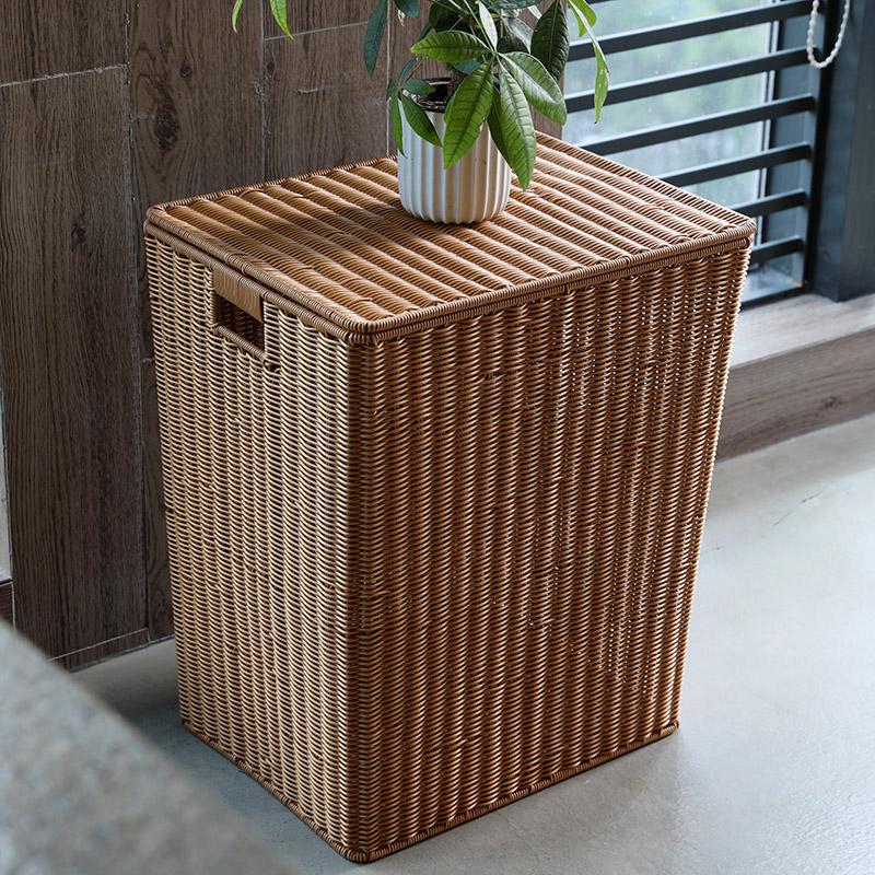Hand-braided indoor-outdoor rattan trash can with a lid – shown in a room setting (2)