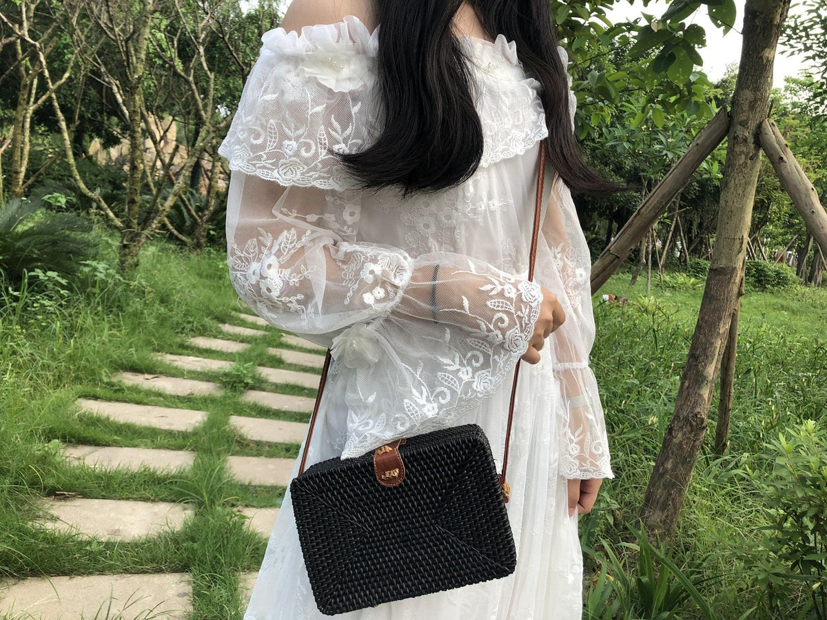 Square boho handwoven rattan handbag – worn by a model