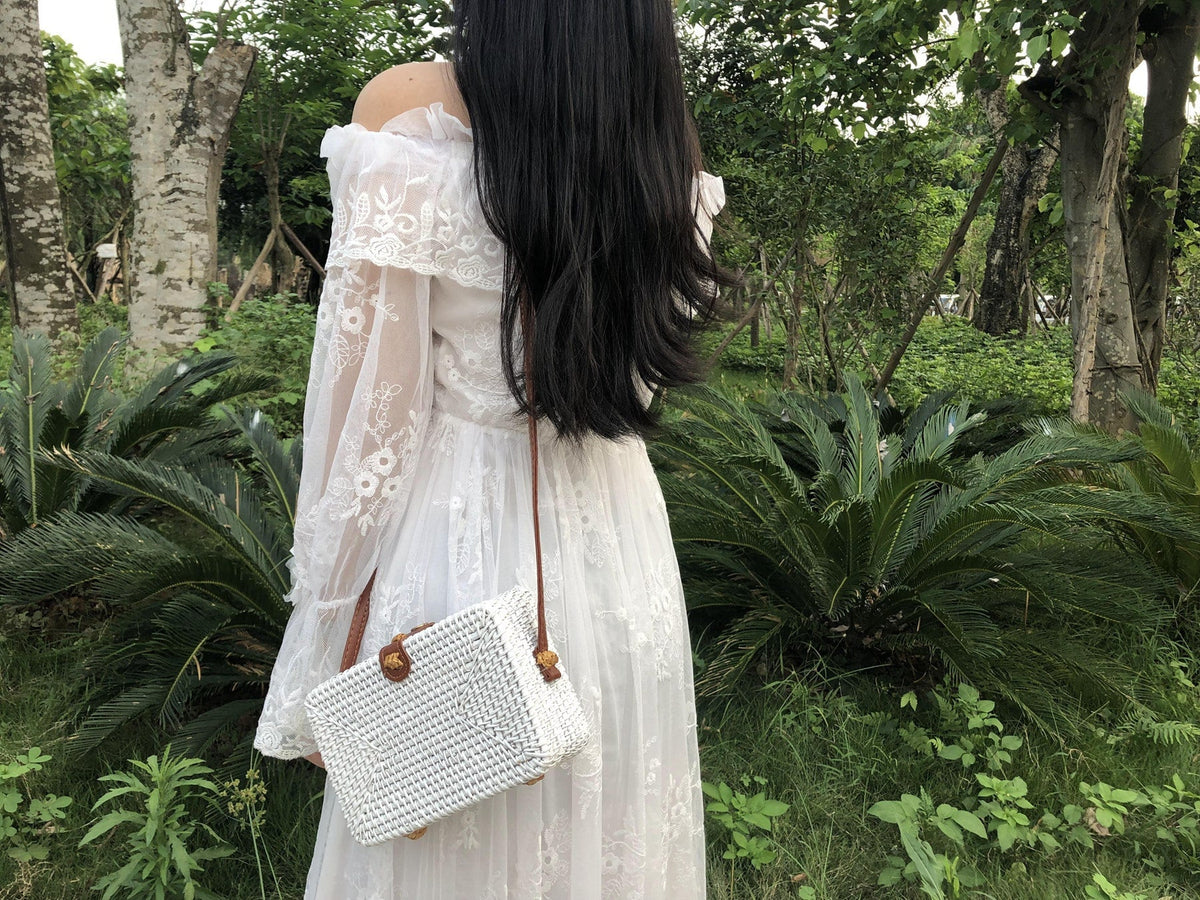 Square boho handwoven rattan handbag – worn by a model (2)