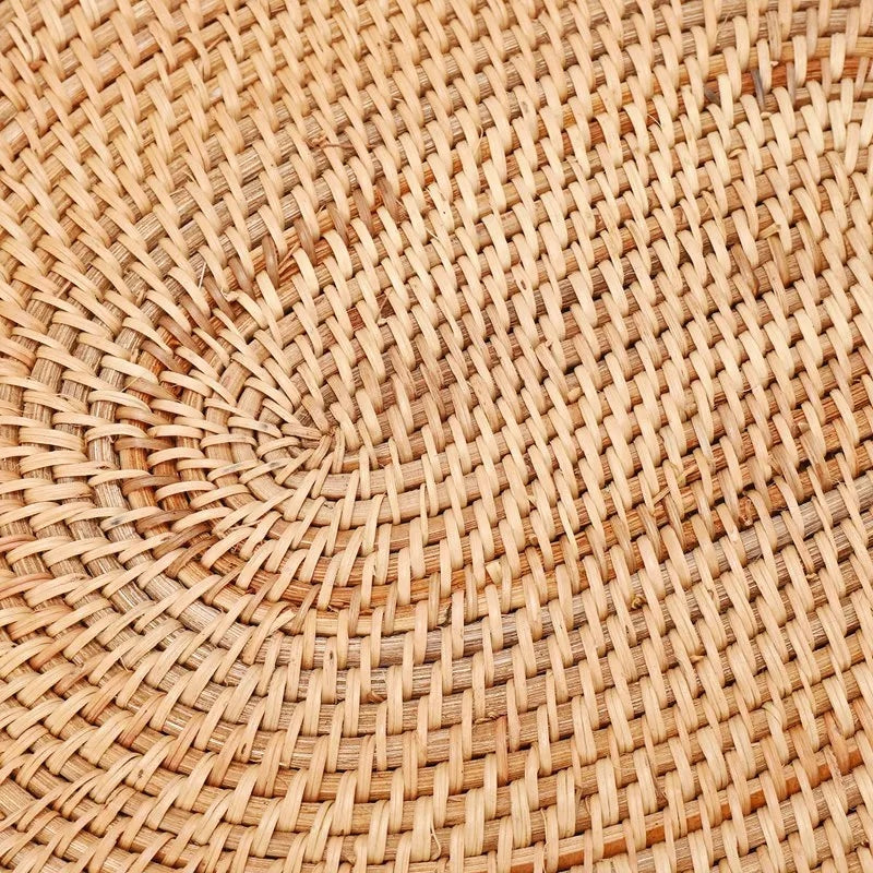 Oval natural rattan placemat in an untreated honey tone – close-up detail