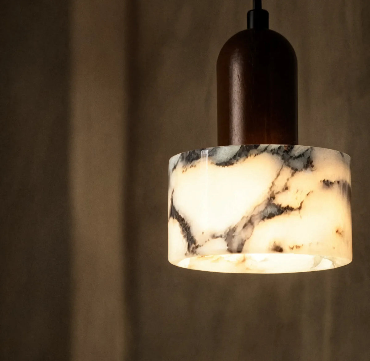 Himère marble and dark wood pendant light – close-up detail, lit