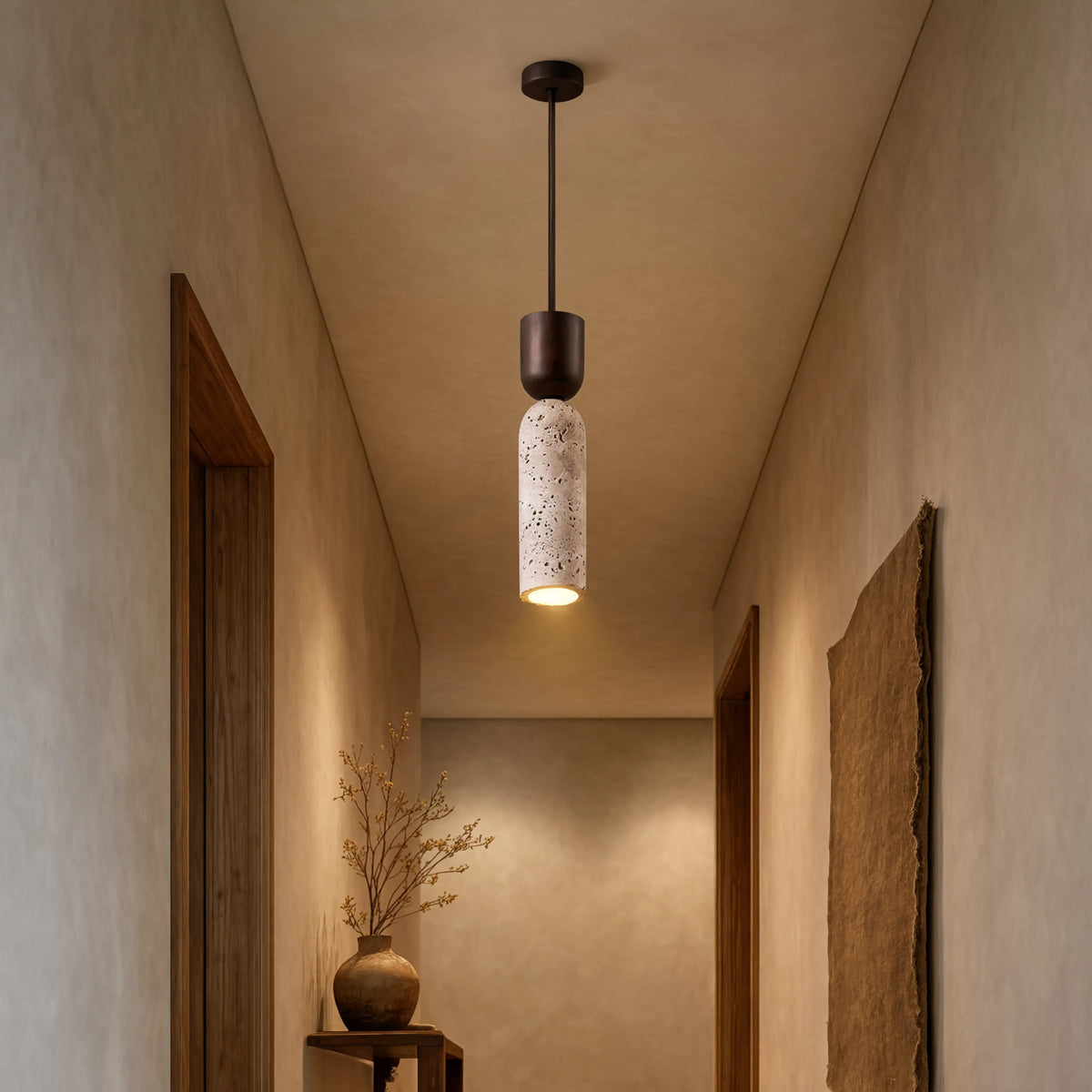 Ségeste narrow travertine and dark wood pendant light – shown in an entryway