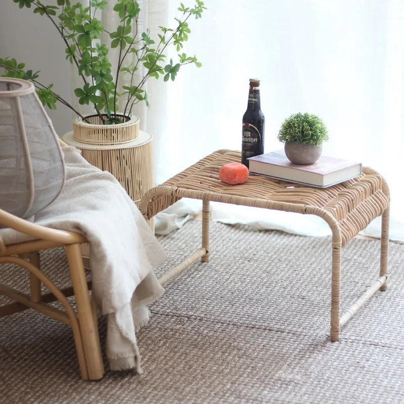 Rectangular wicker coffee table on natural wood legs – shown in a room setting